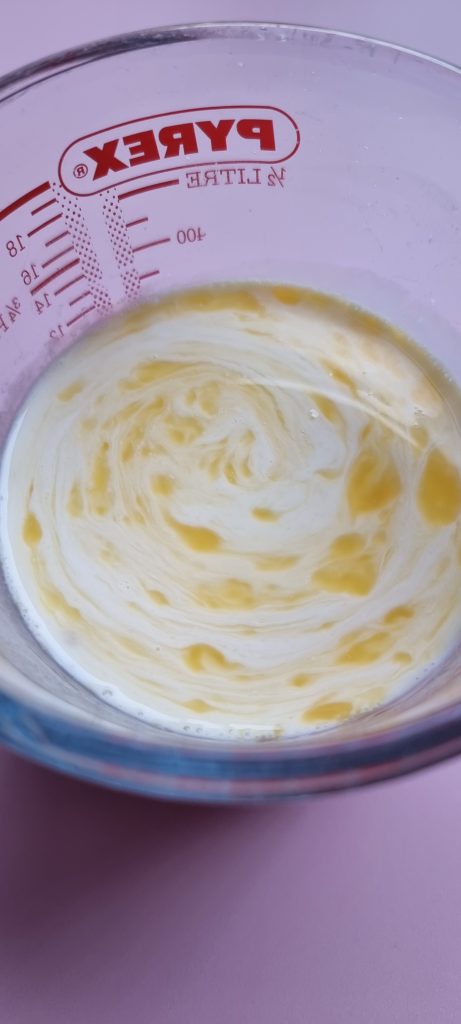 Jug with milk, egg and vanilla extract mixed
